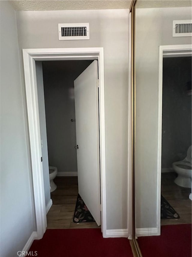 21205 Serra Unit 42, Lake Forest, CA 92630 - bathroom featuring toilet, baseboards, and visible vents