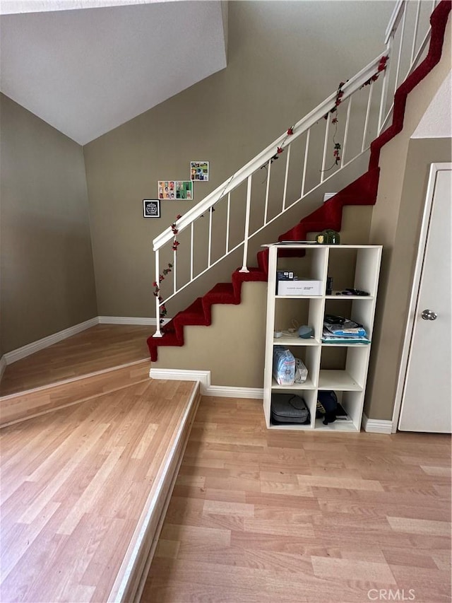 21205 Serra Unit 42, Lake Forest, CA 92630 - stairs featuring vaulted ceiling, baseboards, and wood finished floors