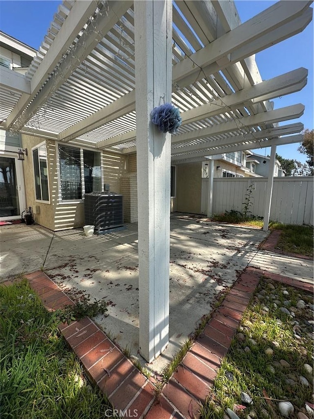 21205 Serra Unit 42, Lake Forest, CA 92630 - view of patio featuring central AC unit, a pergola, and fence