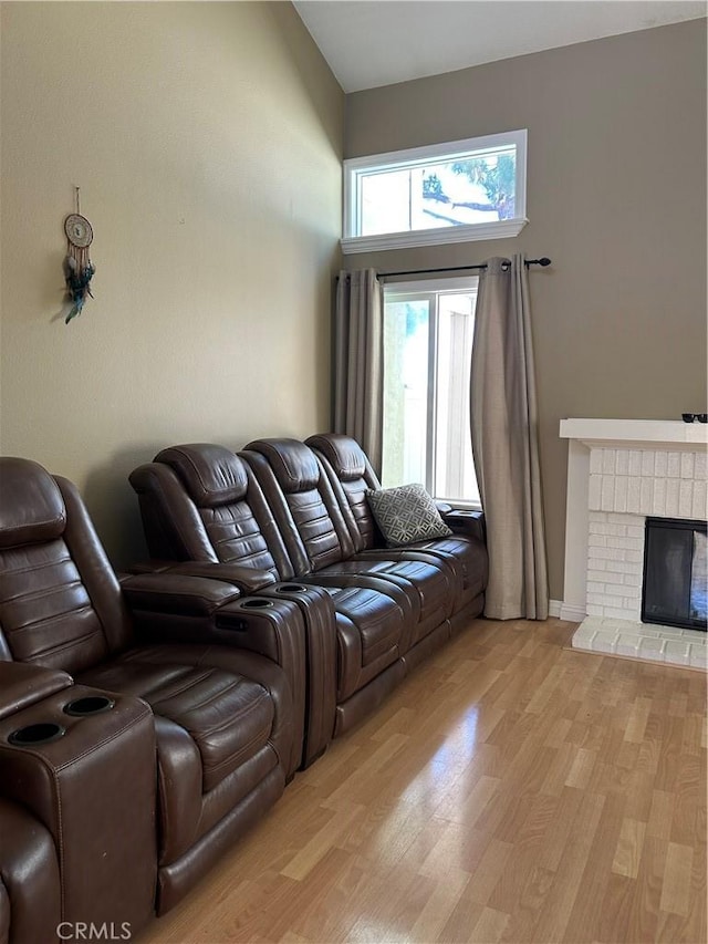 21205 Serra Unit 42, Lake Forest, CA 92630 - living area featuring light wood-type flooring and a fireplace