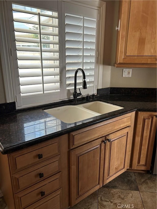21205 Serra Unit 42, Lake Forest, CA 92630 - kitchen featuring plenty of natural light, brown cabinets, and dark stone counters
