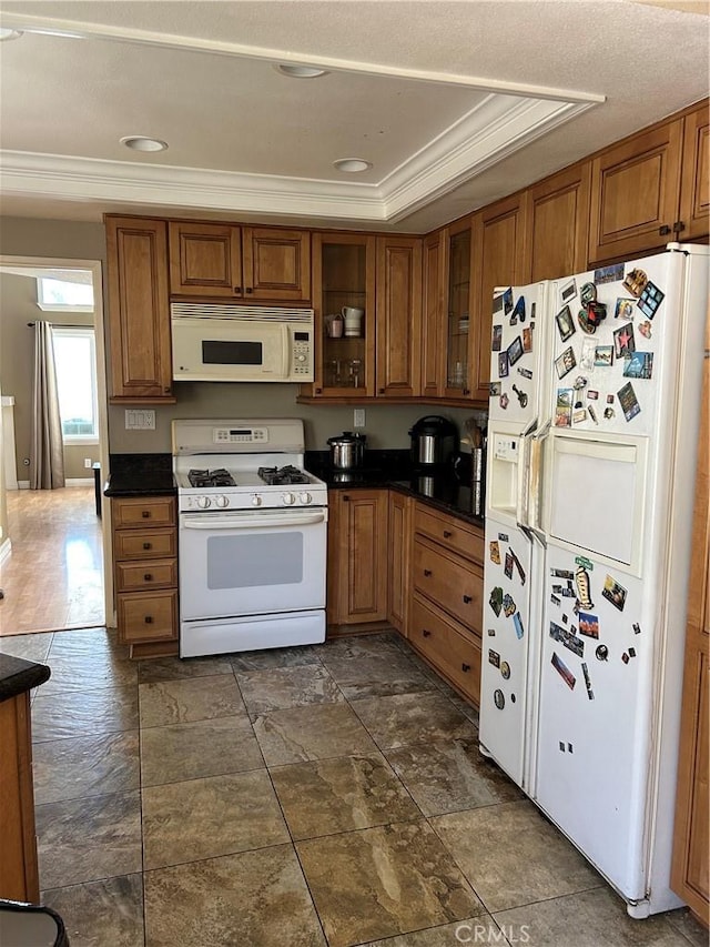 21205 Serra Unit 42, Lake Forest, CA 92630 - kitchen with white appliances, brown cabinetry, ornamental molding, dark countertops, and glass insert cabinets