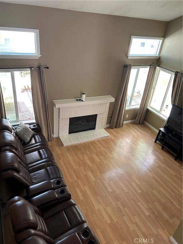 21205 Serra Unit 42, Lake Forest, CA 92630 - living area featuring plenty of natural light, wood finished floors, and a fireplace