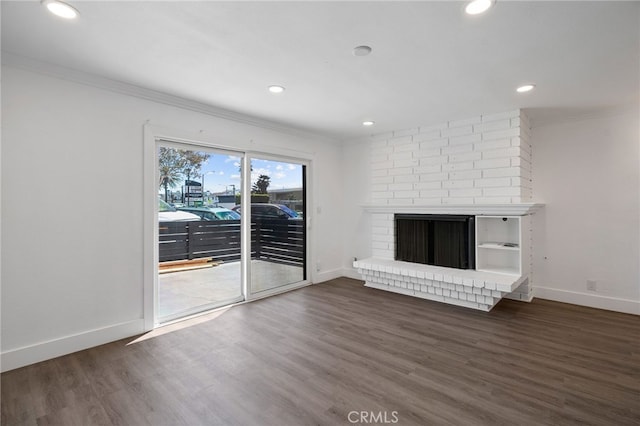 unfurnished living room featuring baseboards, ornamental molding, and dark wood-style floors