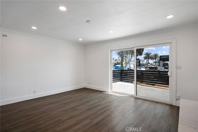 empty room with recessed lighting, baseboards, dark wood finished floors, and ornamental molding