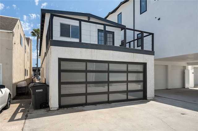 view of front of house featuring a garage, driveway, and stucco siding