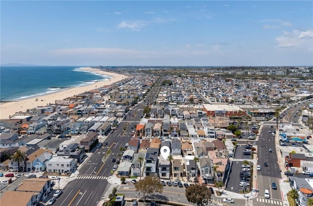 drone / aerial view with a beach view and a water view