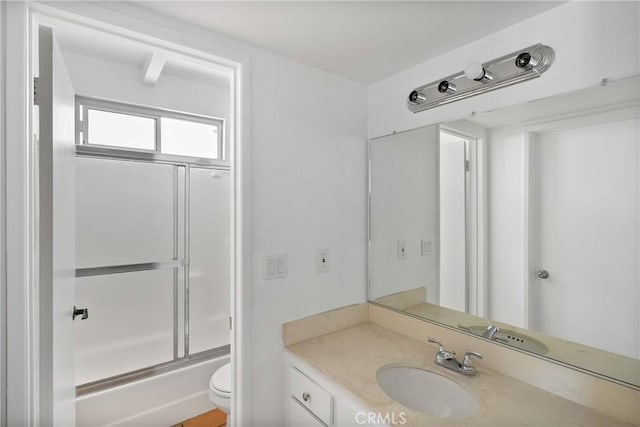 207 28th St, Newport Beach, CA 92663 - bathroom featuring toilet, vanity, and bath / shower combo with glass door