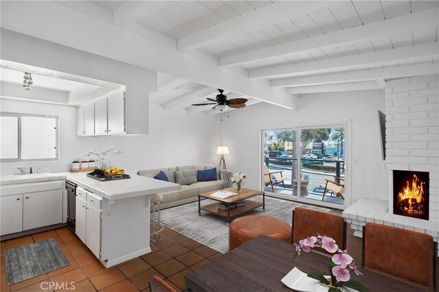207 28th St, Newport Beach, CA 92663 - living room featuring light tile patterned flooring, a fireplace, ceiling fan, and wood ceiling