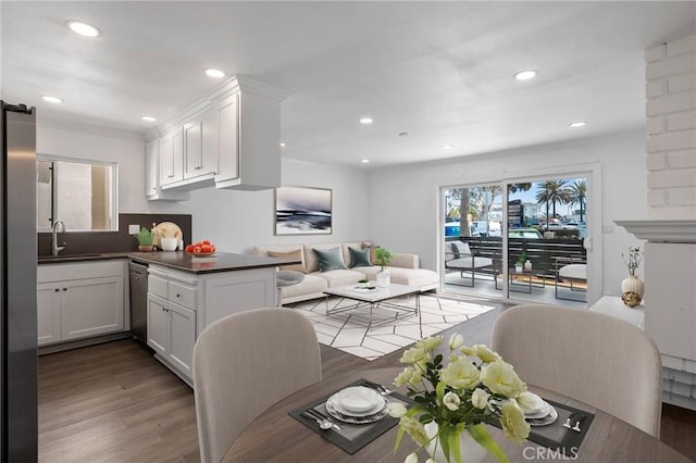 207 28th St, Newport Beach, CA 92663 - kitchen with appliances with stainless steel finishes, white cabinetry, open floor plan, dark countertops, and ornamental molding
