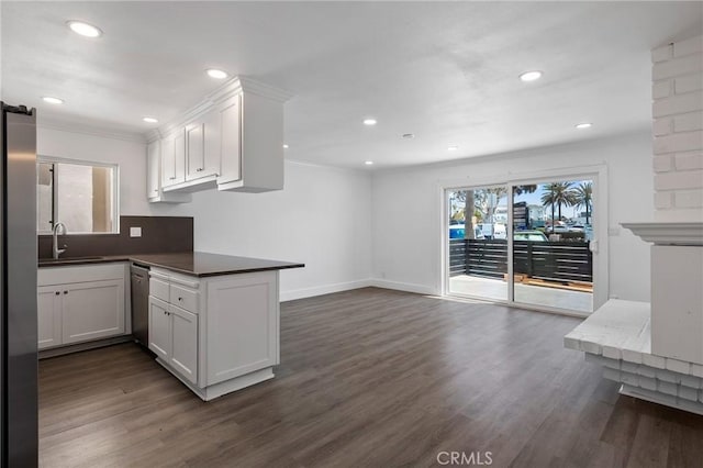 207 28th St, Newport Beach, CA 92663 - kitchen featuring stainless steel appliances, white cabinetry, ornamental molding, dark wood finished floors, and recessed lighting