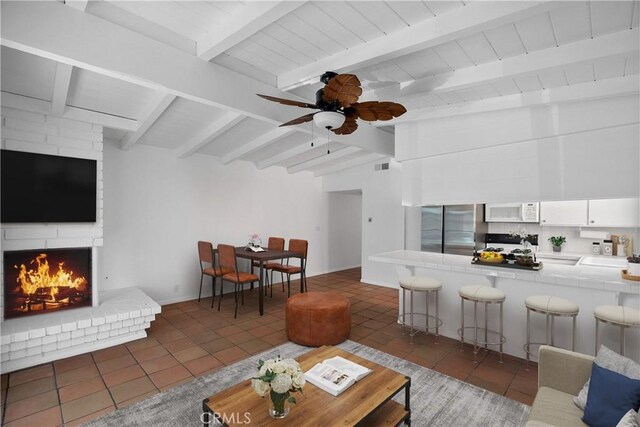 207 28th St, Newport Beach, CA 92663 - living area with tile patterned floors, a brick fireplace, ceiling fan, wooden ceiling, and baseboards