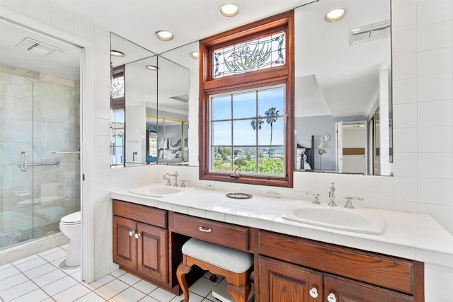 full bath featuring tile patterned floors, visible vents, a shower stall, and a sink