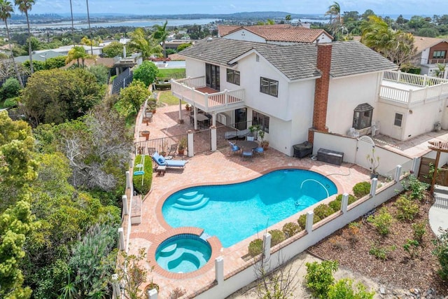 back of house featuring a fenced backyard, stucco siding, a patio area, and a balcony