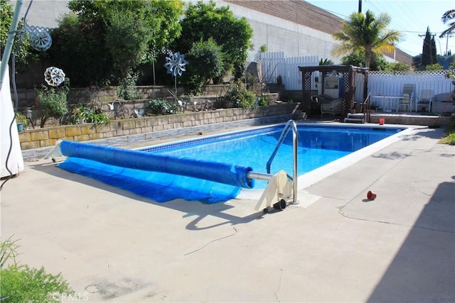view of swimming pool with a fenced in pool, a fenced backyard, and a patio area