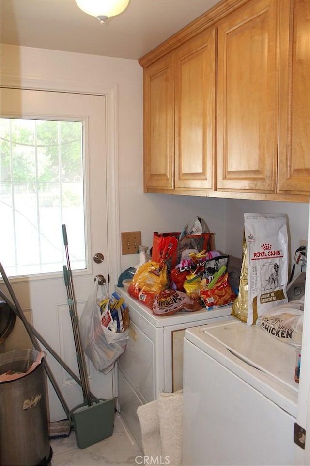washroom with cabinet space and washer and clothes dryer