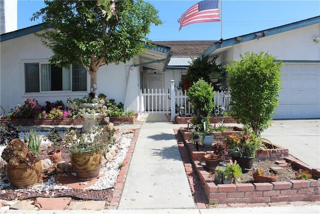 view of front of home with an attached garage and stucco siding