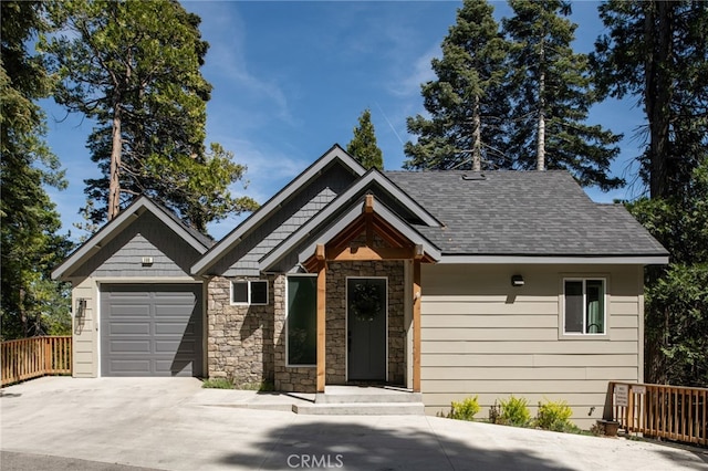 388 Primrose Cir, Lake Arrowhead, CA 92352 - craftsman house with roof with shingles, fence, an attached garage, stone siding, and concrete driveway