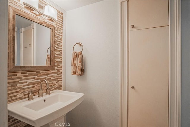 bathroom featuring backsplash and a sink
