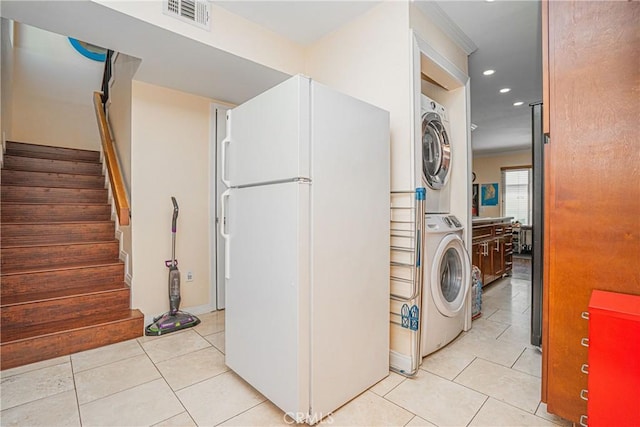 clothes washing area featuring laundry area, visible vents, light tile patterned floors, stacked washer and clothes dryer, and recessed lighting