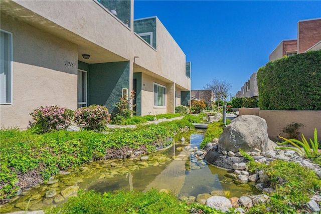 view of yard featuring a small pond