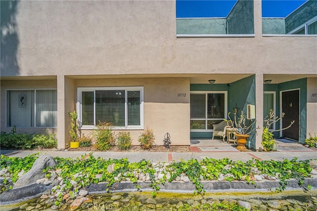 back of property featuring stucco siding