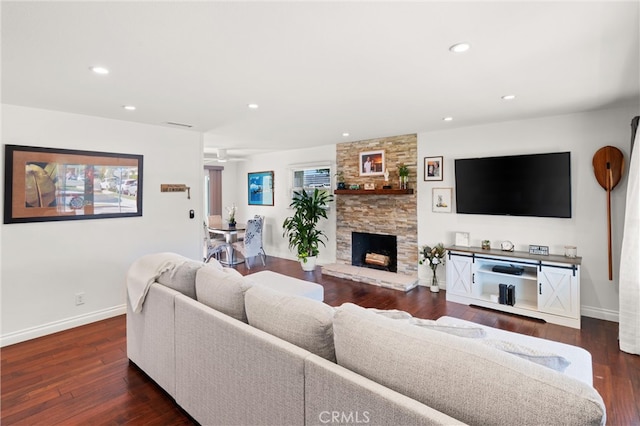 living room with recessed lighting, baseboards, wood finished floors, and a fireplace
