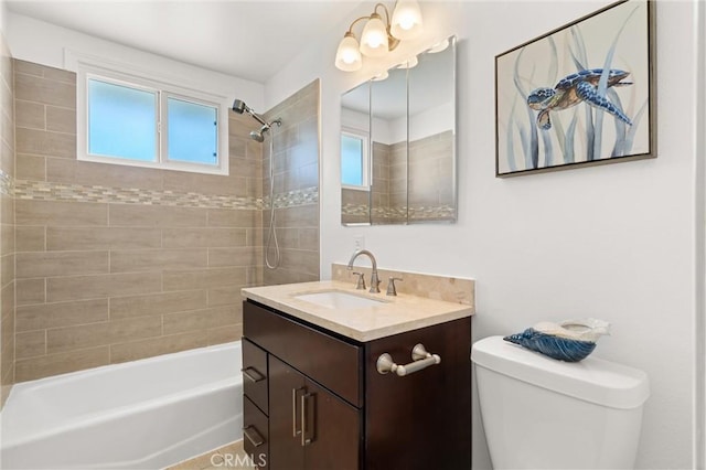 full bathroom with vanity, bathtub / shower combination, a wealth of natural light, and toilet