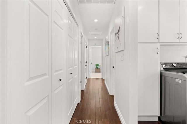 hallway with dark wood-style flooring, washer / clothes dryer, recessed lighting, baseboards, and visible vents