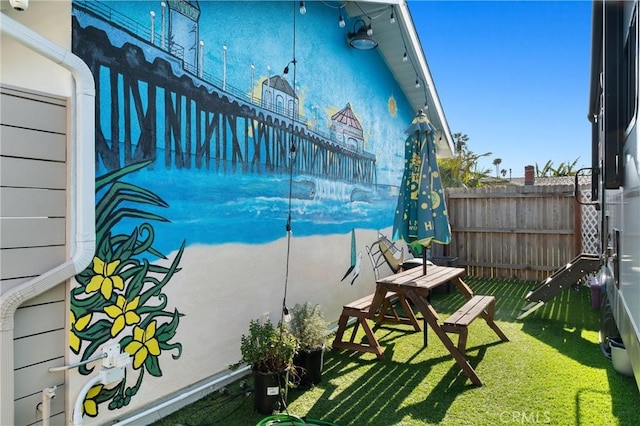view of patio / terrace featuring fence