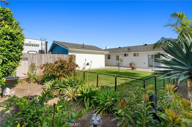 rear view of property with a lawn, fence, and stucco siding