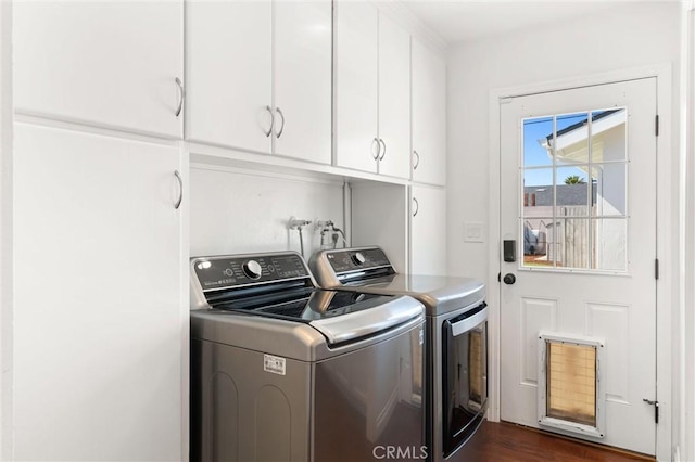 laundry area featuring cabinet space and washing machine and clothes dryer