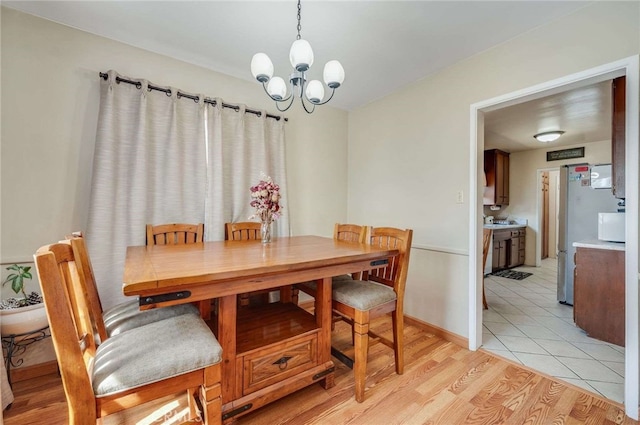 dining area featuring an inviting chandelier and light wood-style floors