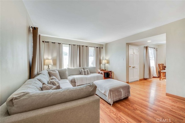 living room featuring baseboards and light wood finished floors