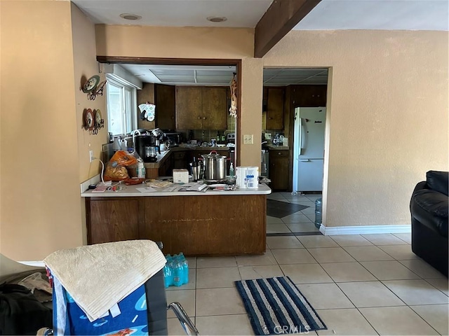 4644 La Canada Rd, Fallbrook, CA 92028 - kitchen featuring freestanding refrigerator, a peninsula, and light tile patterned flooring
