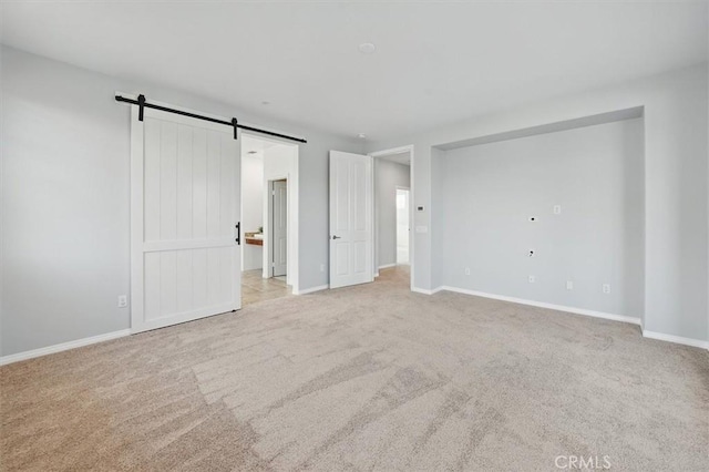 interior space with baseboards and a barn door