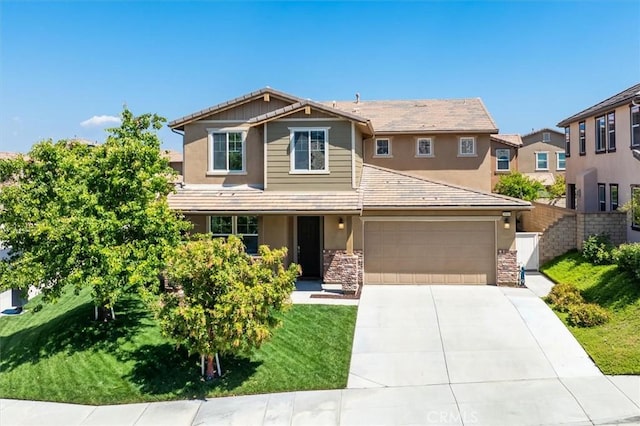 craftsman-style home featuring concrete driveway, fence, and stucco siding