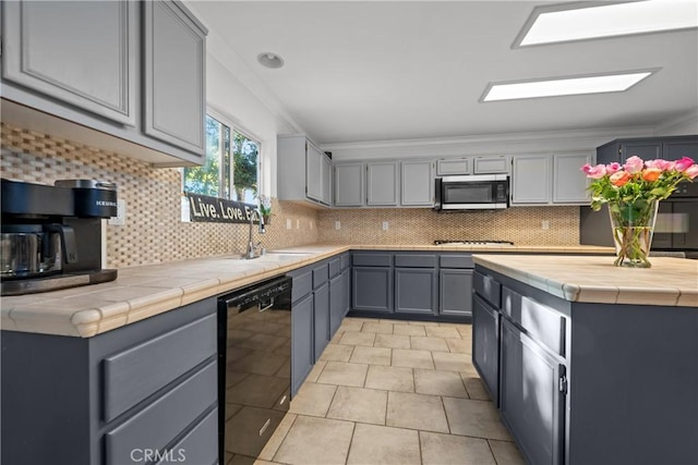 46140 Grace Ct, Temecula, CA 92592 - kitchen featuring stainless steel microwave, black dishwasher, a sink, gray cabinets, and ornamental molding