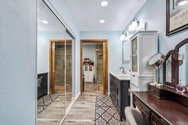 1315 Hermana Ct, Vista, CA 92084 - full bath with wood finished floors, vanity, a stall shower, recessed lighting, and a textured wall