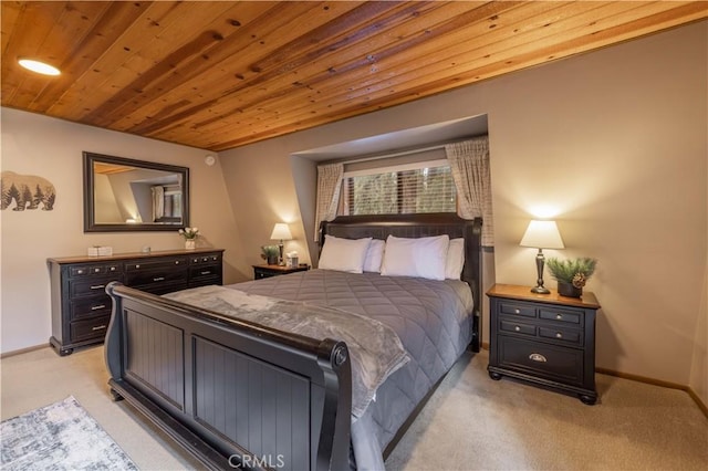 bedroom with wooden ceiling, baseboards, and light carpet