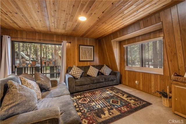 living area with carpet floors, wood walls, and wood ceiling