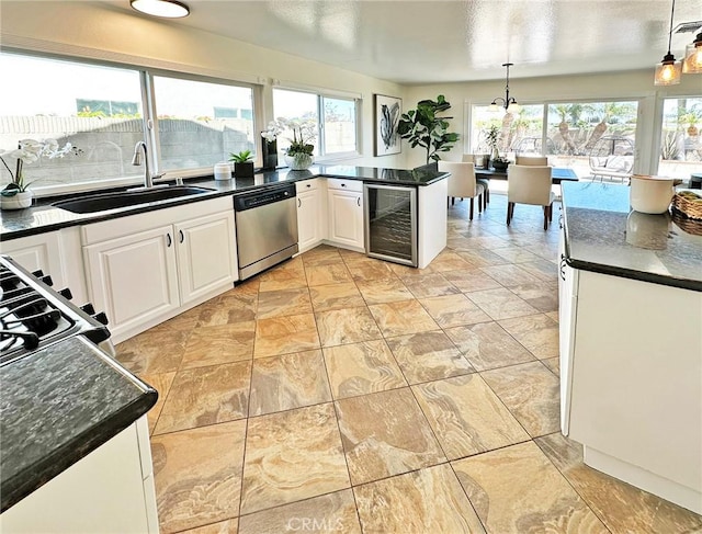kitchen with a sink, a healthy amount of sunlight, stainless steel dishwasher, and wine cooler