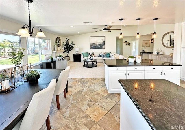 kitchen with ceiling fan, visible vents, hanging light fixtures, light carpet, and white cabinetry