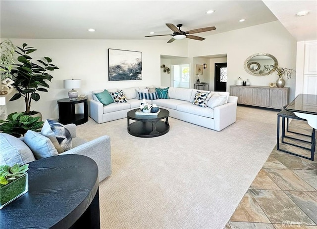 living area with a ceiling fan, recessed lighting, and stone finish floor