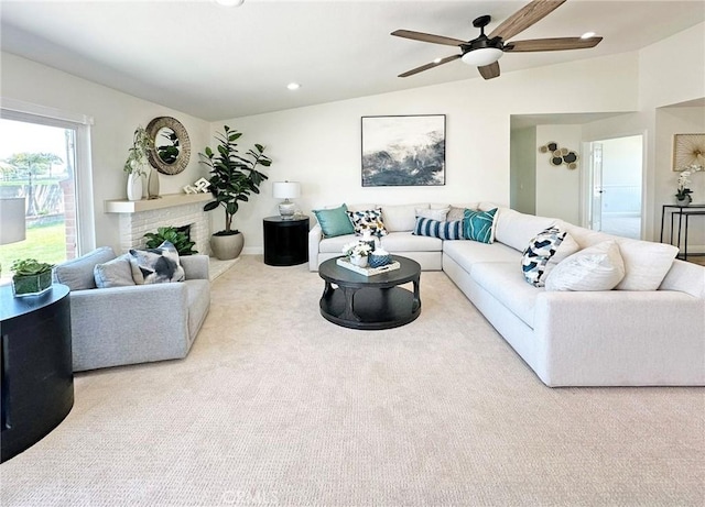 carpeted living area with recessed lighting, ceiling fan, lofted ceiling, and a fireplace