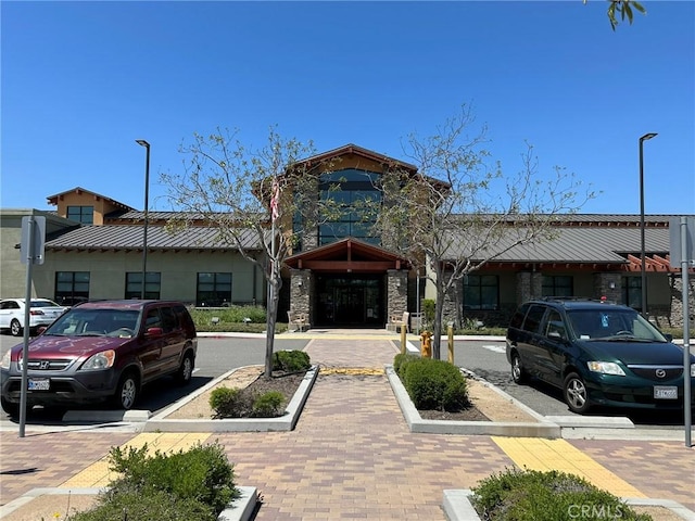 view of building exterior with uncovered parking