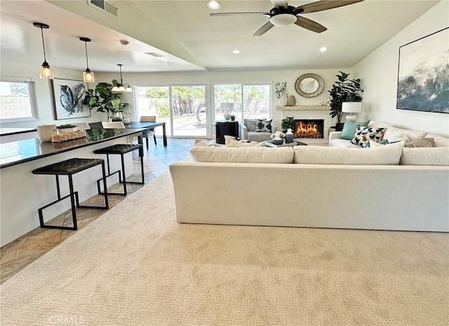 living area with recessed lighting, ceiling fan, visible vents, and a fireplace