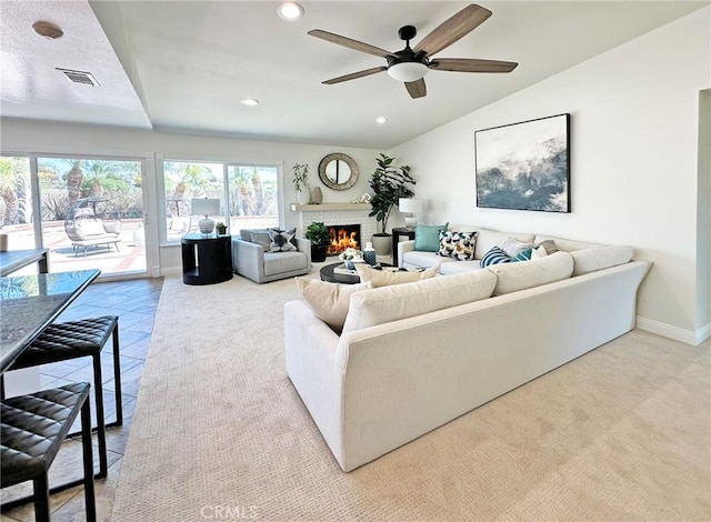 living area with visible vents, a fireplace, baseboards, recessed lighting, and a ceiling fan