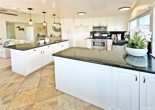 kitchen with white cabinetry, a peninsula, and stainless steel appliances