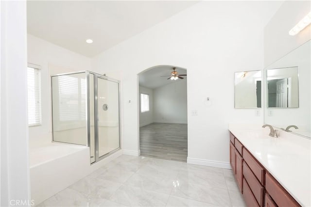 bathroom featuring double vanity, marble finish floor, baseboards, a ceiling fan, and a stall shower